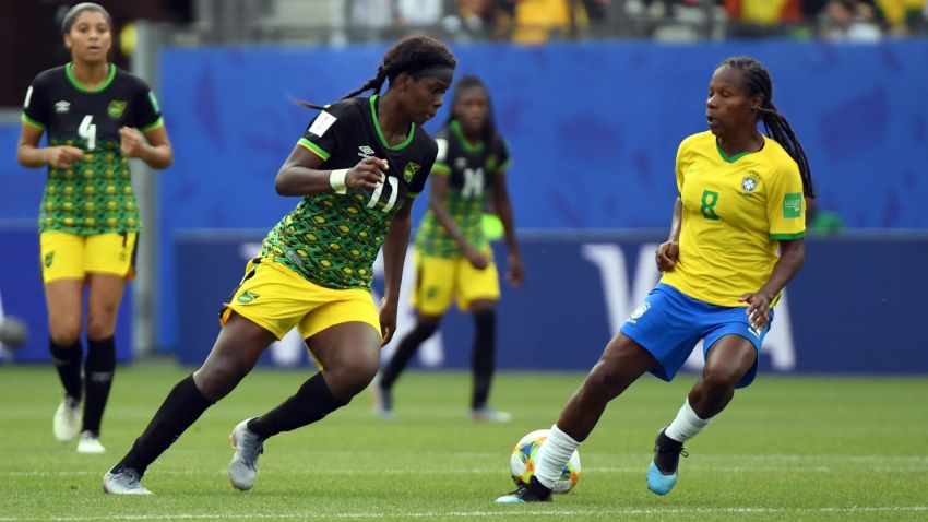 Jamaica's forward Khadija Shaw (L) vies with Brazil's midfielder Formiga (R)  during the France 2019 Women's World Cup Group C football match between Brazil and Jamaica on June 9, 2019, at the Alpes Stadium in Grenoble, central-eastern France. (Photo by Jean-Pierre Clatot / AFP)        (Photo credit should read JEAN-PIERRE CLATOT/AFP/Getty Images)