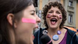 Two women shout during a nation-wide women's strike for wage parity, on June 14, 2019 in Lausanne. - Nearly 30 years after staging a first strike, women across Switzerland stage mass demonstrations for for equal pay. Events planned throughout the day range from pram marches, to whistle concerts, to extended lunch breaks and giant picnics, with huge demonstrations planned on June 14 evening in several cities, including in front of the government in Bern. (Photo by FABRICE COFFRINI / AFP)        (Photo credit should read FABRICE COFFRINI/AFP/Getty Images)
