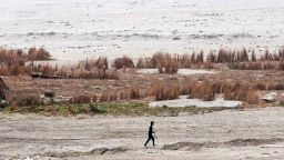 A man crosses the dried river bed of the shrunken Ganges in Allahabad on June 12.