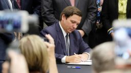 Florida Gov. Ron DeSantis signs the Sanctuary City bill Friday, June 14, 2019 at the Okaloosa County, Fla., Commission Chambers in Shalimar Fla. The bill requires all law enforcement agencies in Florida to cooperate with federal immigration authorities. 