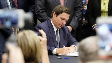 Florida Gov. Ron DeSantis signs a bill banning sanctuary cities on Friday.