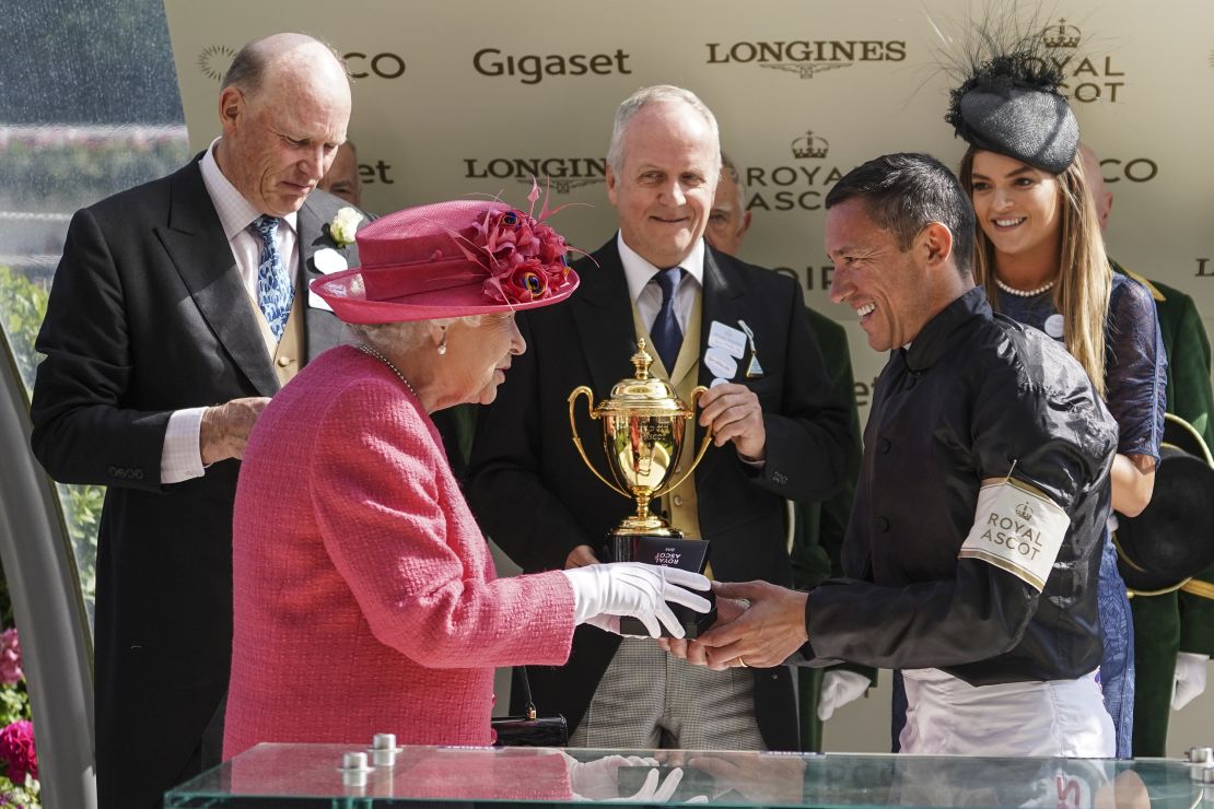 Queen Elizabeth II presents Frankie Dettori with the Ascot Gold Cup in 2018. 