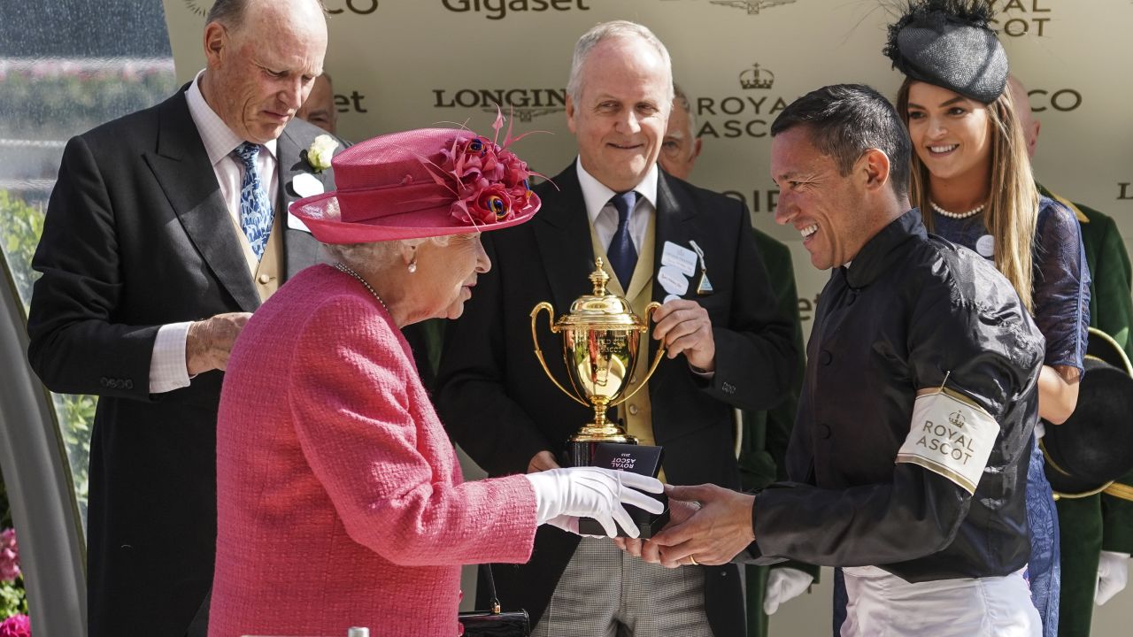 Queen Elizabeth II presents Frankie Dettori with the Ascot Gold Cup in 2018.