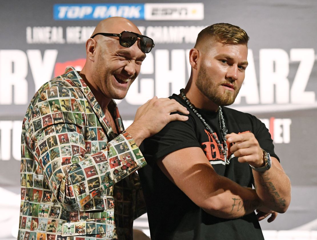 Boxers Tyson Fury (left) and Tom Schwarz pose ahead of their heavyweight bout.