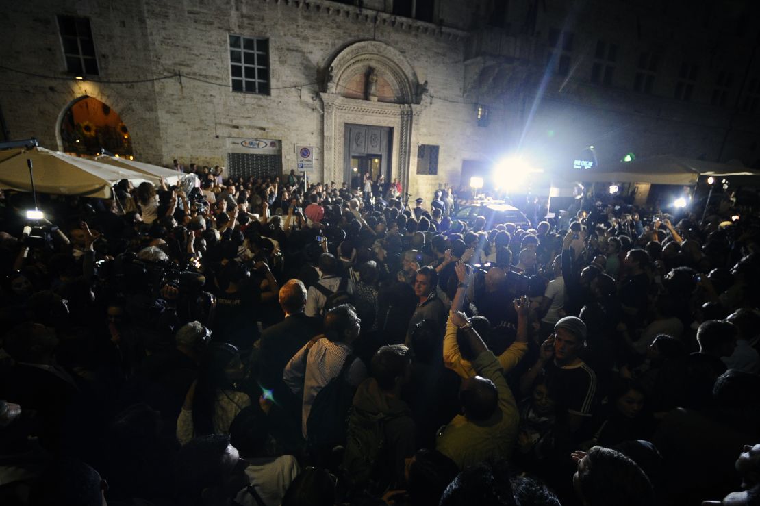 People and media gather outside Perugia's court before the appeal verdict is announced on October 3, 2011.