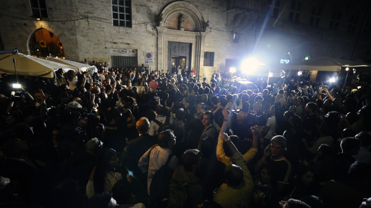 People and media gather outside Perugia's court before the appeal verdict is announced on October 3, 2011.