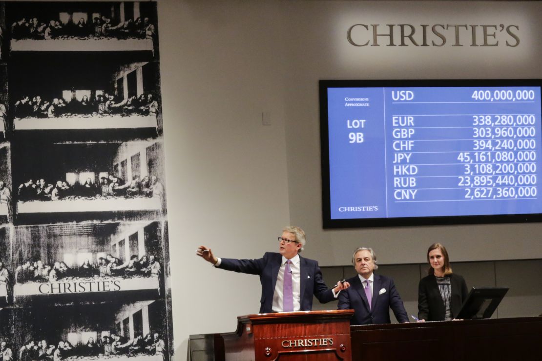 Bidding hits $400 million at Christie's in New York in November 2017. After fees, the painting's final sale price was $450.3 million. 