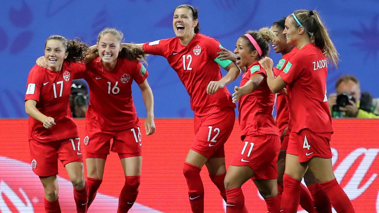 Jessie Fleming celebrates with her Canadian teammates after scoring her team's first goal.