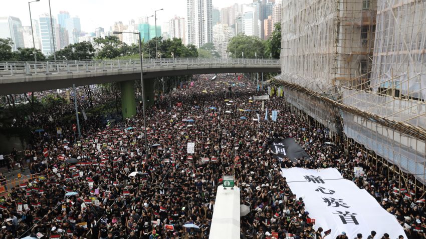 Protesters march during a rally in Hong Kong, China, on Sunday, June 16, 2019. Tens of thousands of demonstrators poured into central Hong Kong as organizers remained defiant even after the city's leader suspended consideration of the China-backed extradition plan that sparked some of the biggest protests in the city in decades. Photographer: Kyle Lam/Bloomberg via Getty Images