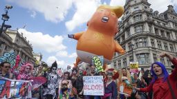 A giant balloon depicting US President Donald Trump as an orange baby joins drag queens and protesters against the UK visit of US President Donald Trump as they take part in a march and rally in London on July 13, 2018. - Tens of thousands of protesters demonstrated in London on Friday against US President Donald Trump, whose four-day visit to Britain has been marred by his extraordinary attack on Prime Minister Theresa May's Brexit strategy. (Photo by Niklas HALLEN / AFP)        (Photo credit should read NIKLAS HALLEN/AFP/Getty Images)