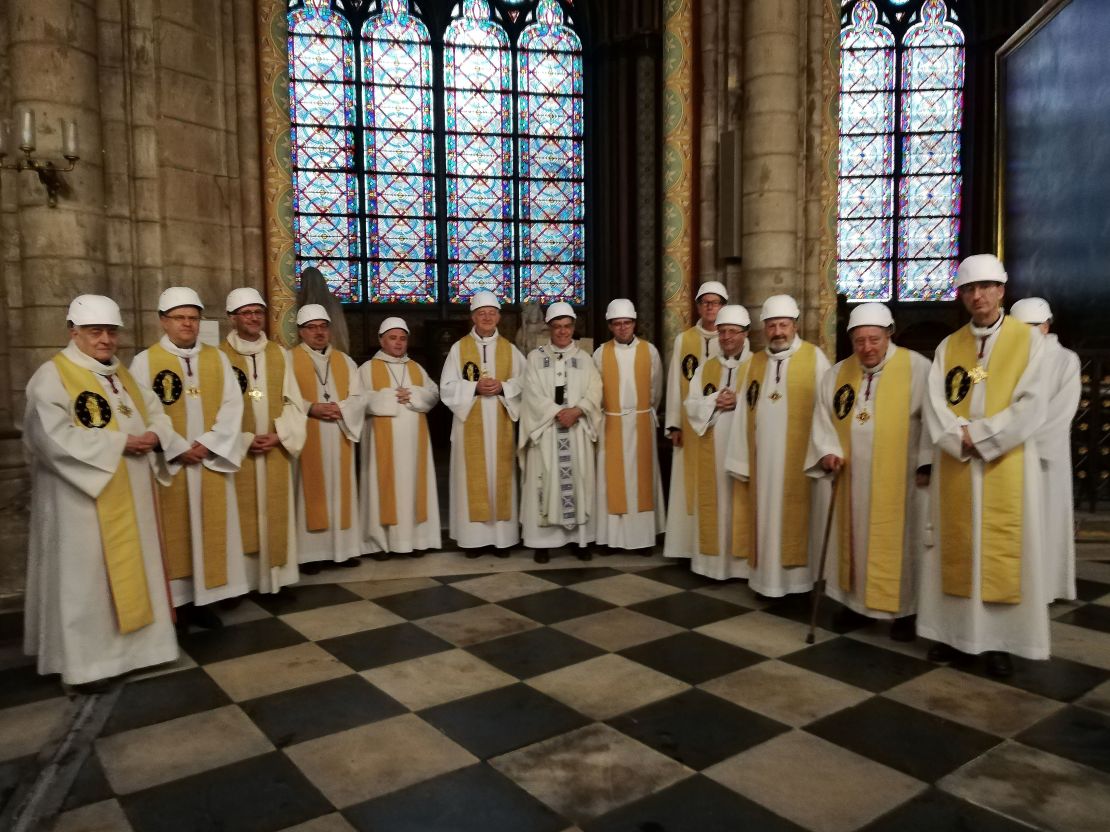 Michel Aupetit, the Archbishop of Paris (center), poses with other members of the clergy following the Mass.