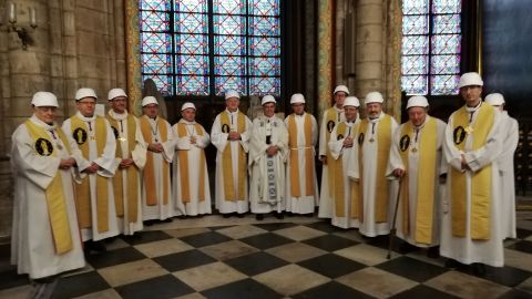 Michel Aupetit, the Archbishop of Paris (center), poses with other members of the clergy following the Mass.