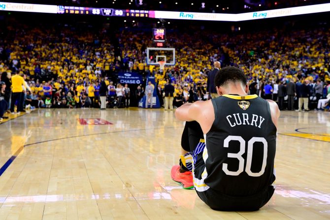 Golden State Warriors guard Stephen Curry reacts after teammate Klay Thompson injured his knee in Game 6 of the <a href="index.php?page=&url=https%3A%2F%2Fwww.cnn.com%2F2019%2F06%2F13%2Fsport%2Fgallery%2Fnba-finals-2019%2Findex.html" target="_blank">NBA Finals</a> on Thursday, June 13. It was later revealed that Thompson tore his ACL. In Game 5, Warriors forward Kevin Durant ruptured his Achilles tendon.