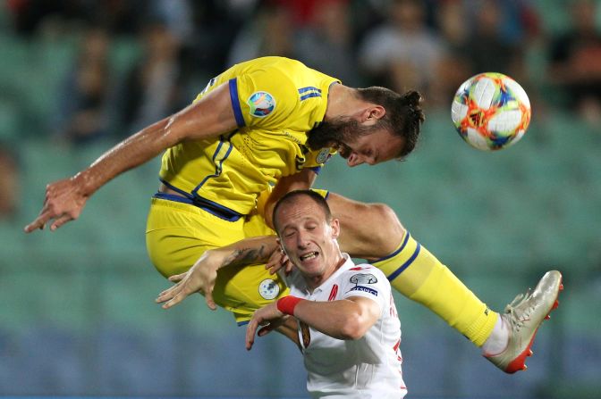 Kosovo's Vedat Muriqi heads the ball over Bulgaria's Anton Nedyalkov during a Euro 2020 qualifier on Monday, June 10.