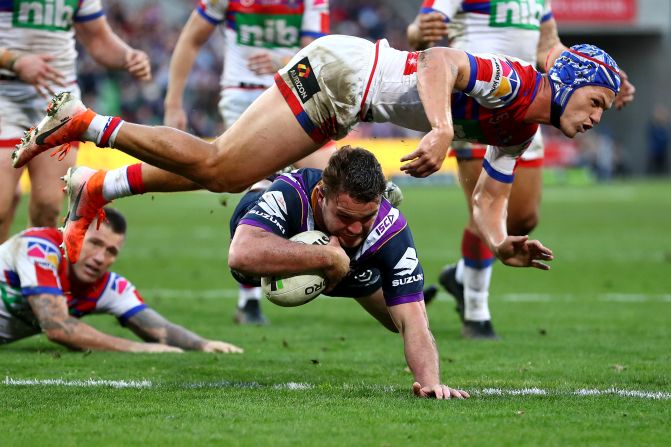 The Melbourne Storm's Joe Stimson scores a try during a rugby match against the Newcastle Knights on Saturday, June 15.