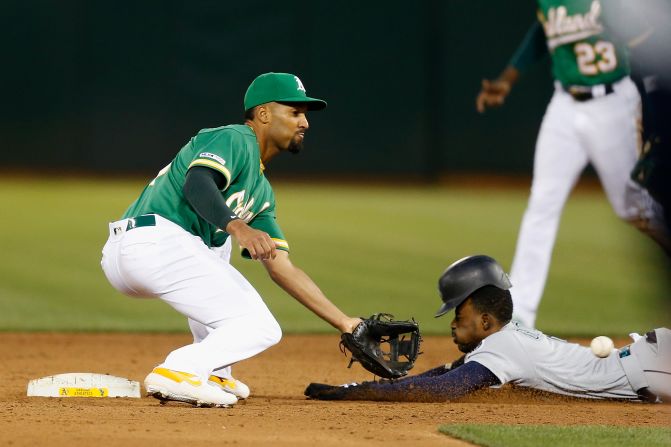 Seattle's Dee Gordon steals second base ahead of the tag from Oakland's Marcus Semien on Friday, June 14.