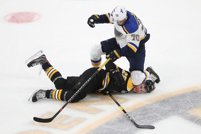 Boston's Brandon Carlo, bottom, is checked by St. Louis' Oskar Sundqvist during Game 7 of the Stanley Cup Final on Wednesday, June 12.