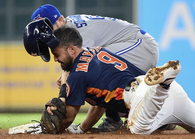 Houston's Jack Mayfield slides safely into second base, beating the tag of Toronto's Eric Sogard on Saturday, June 15.