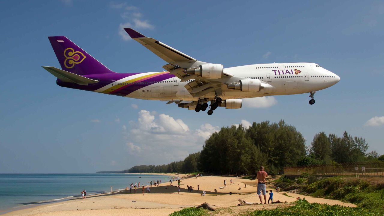 A Thai Airways Boeing 747-400 comes in for a landing over Phuket's Mai Khao beach. 