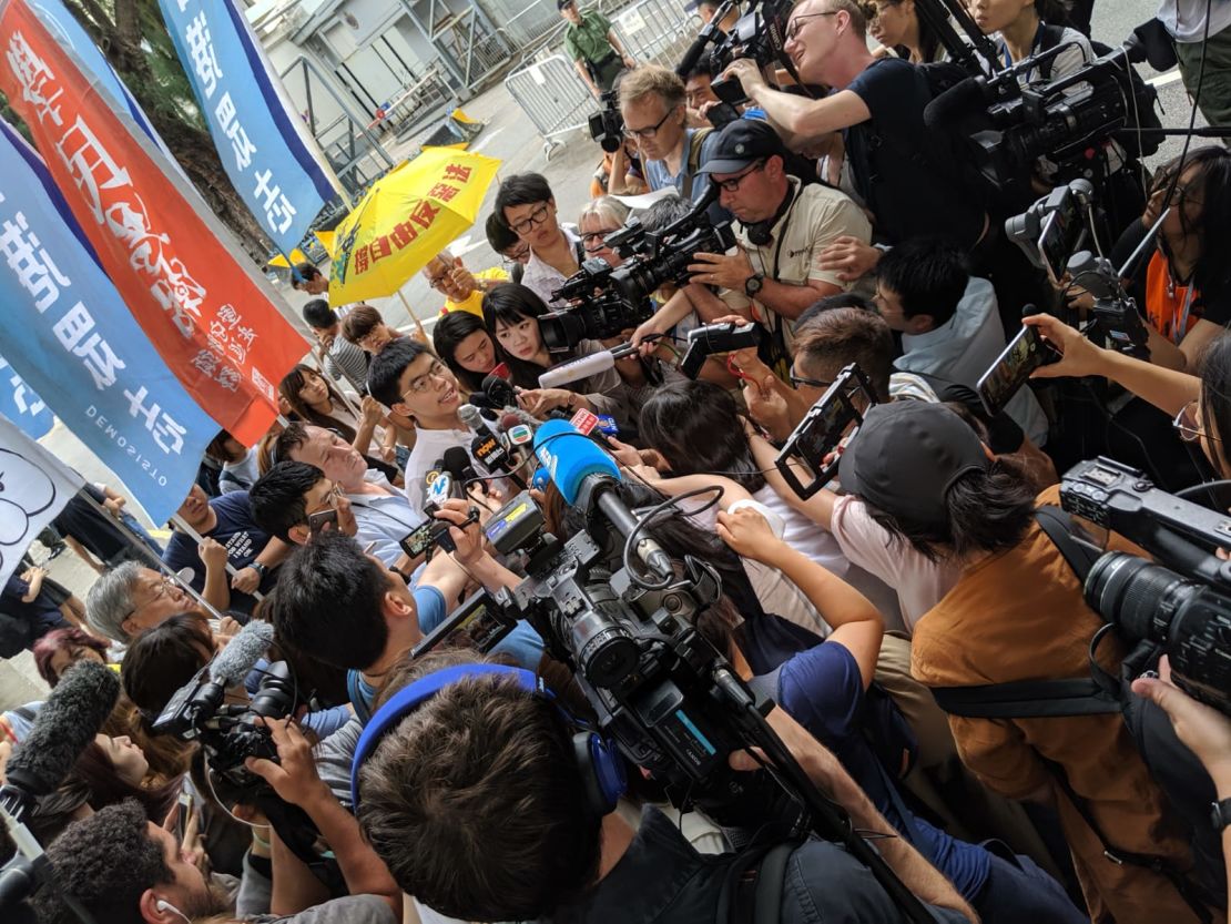 Hong Kong protest icon Joshua Wong is greeted by a scrum of media as he leaves prison on June 17, 2019.