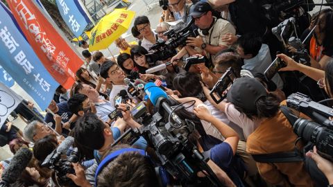 Hong Kong protest icon Joshua Wong is greeted by a scrum of media as he leaves prison on June 17, 2019.