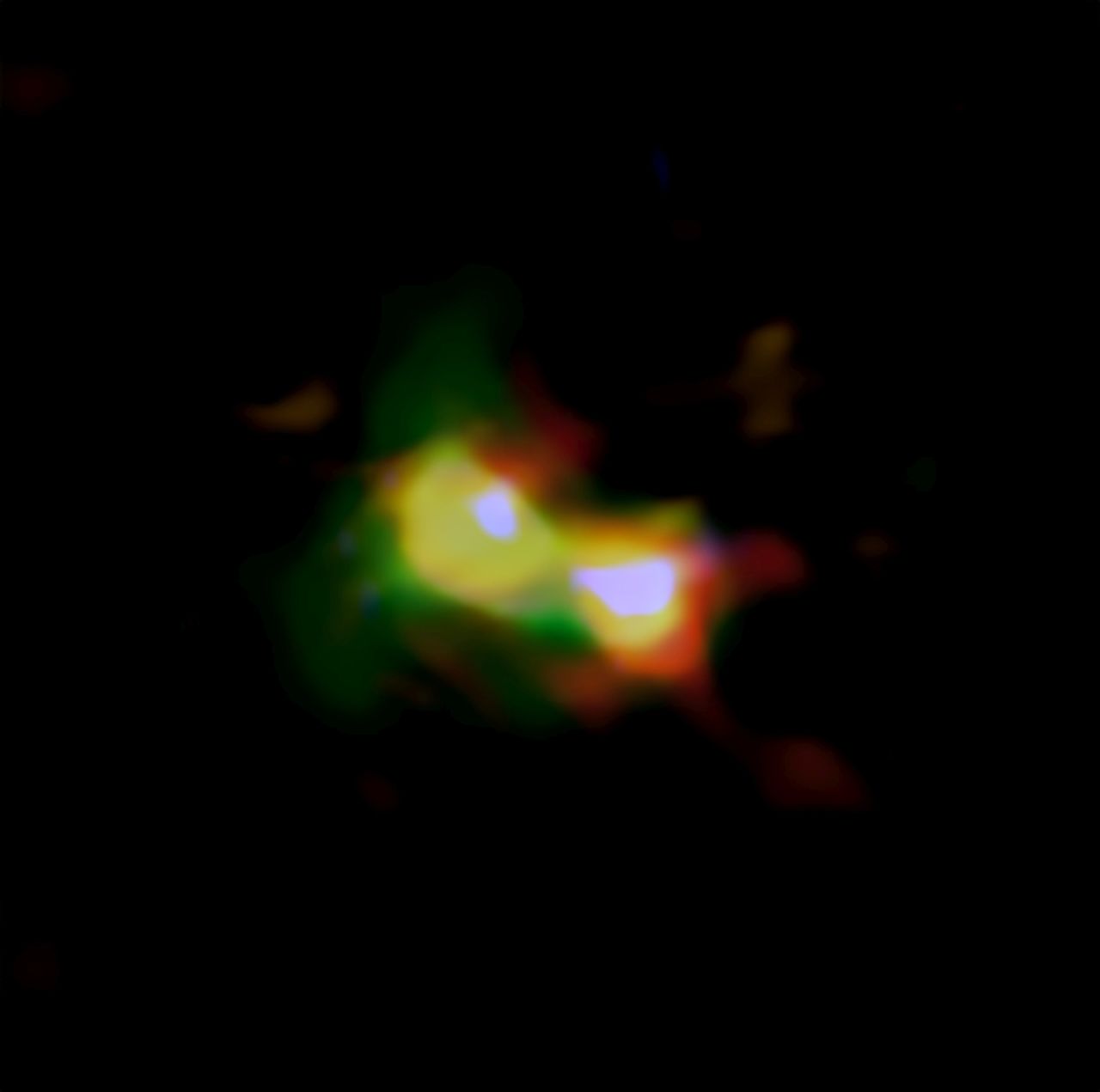 Composite image of B14-65666 showing the distributions of dust (red), oxygen (green), and carbon (blue), observed by ALMA and stars (white) observed by the Hubble Space Telescope.