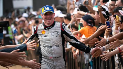 Oliver Rowland celebrates after scoring his first podium in Sanya