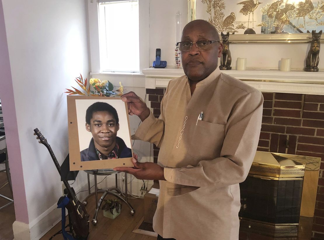 Dia Khafra, father of Askia Khafra, holds a photo of his son in his Silver Spring, Maryland, home. 