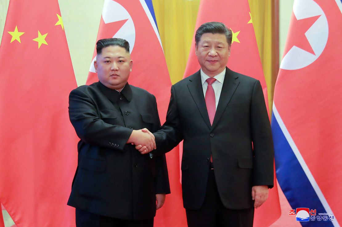 In this Jan. 8 photo provided by the North Korean government, North Korean leader Kim Jong Un, left, and Chinese President Xi Jinping pose for photographs at the Great Hall of the People in Beijing. 