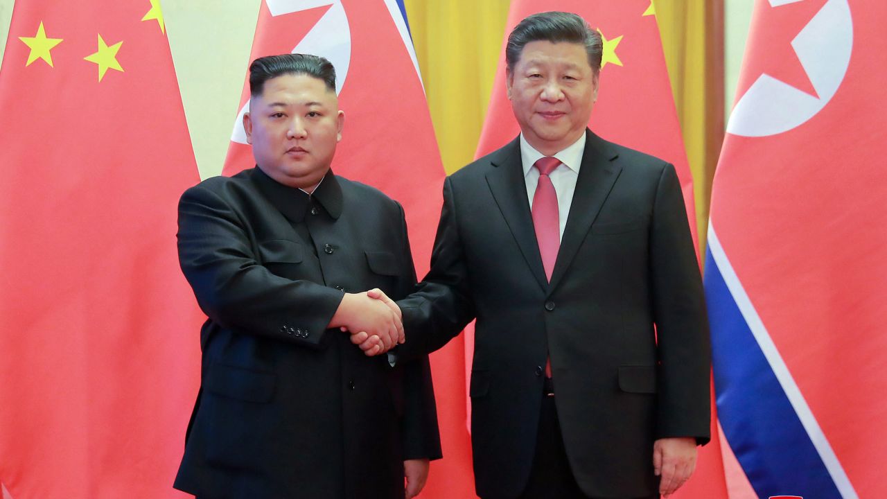 In this Jan. 8 photo provided by the North Korean government, North Korean leader Kim Jong Un, left, and Chinese President Xi Jinping pose for photographs at the Great Hall of the People in Beijing. 