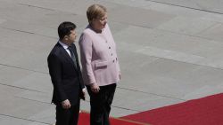 German Chancellor Angela Merkel stands next to Ukraine's President Volodymyr Zelenskiy during military honors for a meeting at the chancellery in Berlin, Germany, Tuesday, June 18, 2019. (AP Photo/Markus Schreiber)