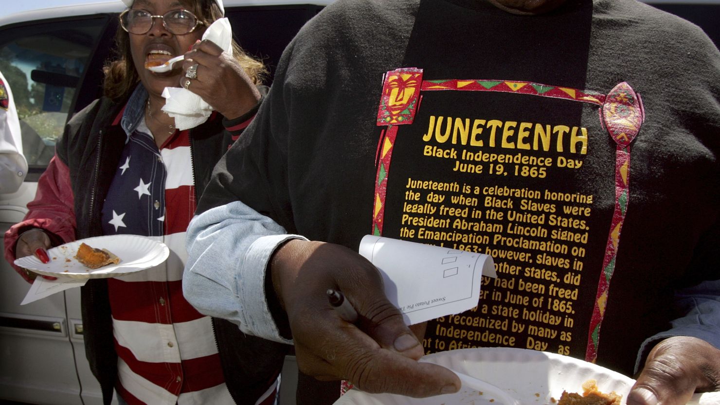 Naomi Williams, left, and D'Emanuel Grosse Sr. taste the sweet potato pie entered in the cook-off contest at the Juneteenth Black Independence Day celebrations in Richmond, California on Wednesday.
