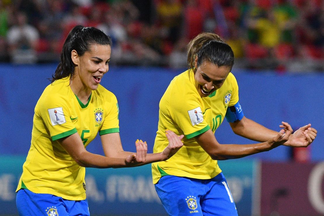 Marta celebrates with Brazil's midfielder Thaisa after scoring against Italy. 