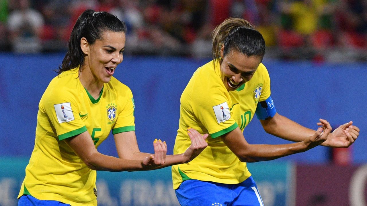 Marta celebrates with Brazil's midfielder Thaisa after scoring against Italy.