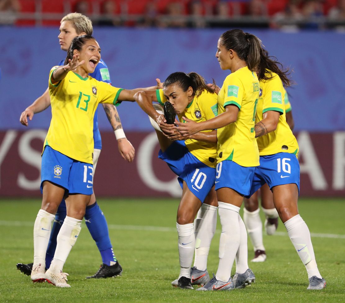 Marta kisses her boot after becoming the first player to score in five Women's World Cup tournaments. 
