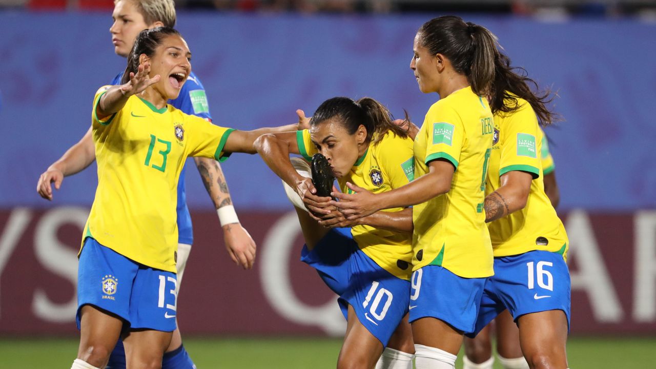 Marta celebrates with teammates after her record-breaking goal.