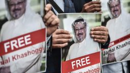 TOPSHOT - Protestors hold pictures of missing journalist Jamal Khashoggi during a demonstration in front of the Saudi Arabian consulate on October 8, 2018 in Istanbul. - Jamal Khashoggi, a veteran Saudi journalist who has been critical towards the Saudi government has gone missing after visiting the kingdom's consulate in Istanbul on October 2, 2018, the Washington Post reported. Turkey has sought permission to search Saudi Arabia's consulate in Istanbul after a prominent journalist from the kingdom went missing last week following a visit to the building, Turkish television reported on October 8. (Photo by OZAN KOSE / AFP)        (Photo credit should read OZAN KOSE/AFP/Getty Images)