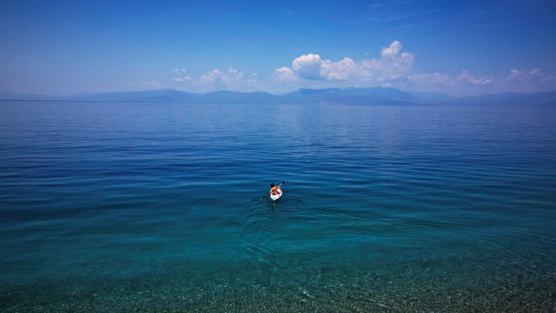 <strong>Derveni, Greece: </strong>A boy paddles his boat in the clear waters off Derveni, a coastal town some 120 kilometers southwest of Athens. 
