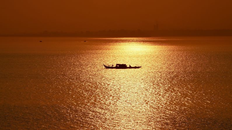 <strong>Phnom Penh:</strong> In the Cambodian capital, a fishing boat travels at sunrise along the Mekong River. <br />