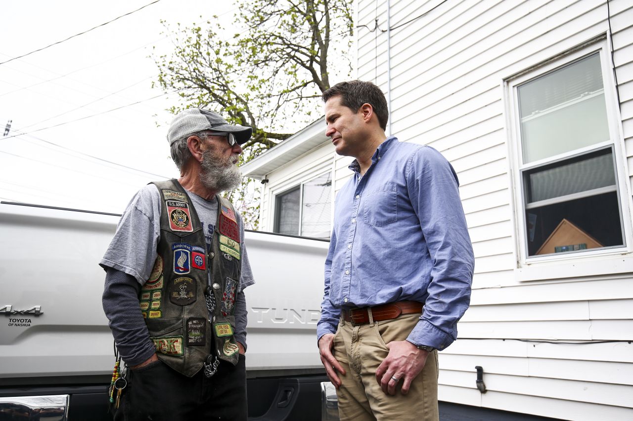 Moulton speaks with a veteran during a campaign stop in Manchester, New Hampshire, in April 2019.