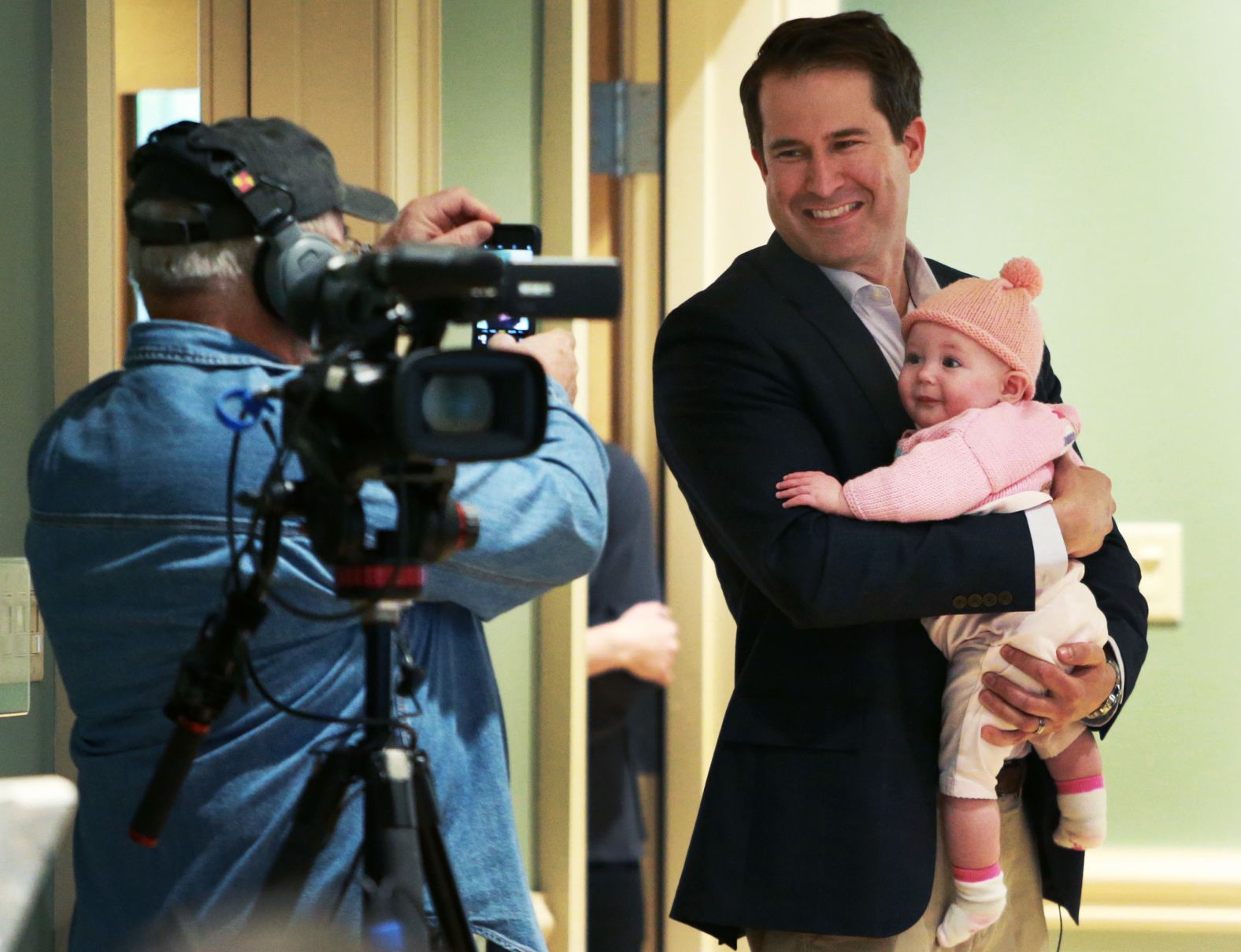 Moulton holds his daughter, Emmy, before a town-hall event in Newburyport, Massachusetts, in May 2019. Emmy is his only child.