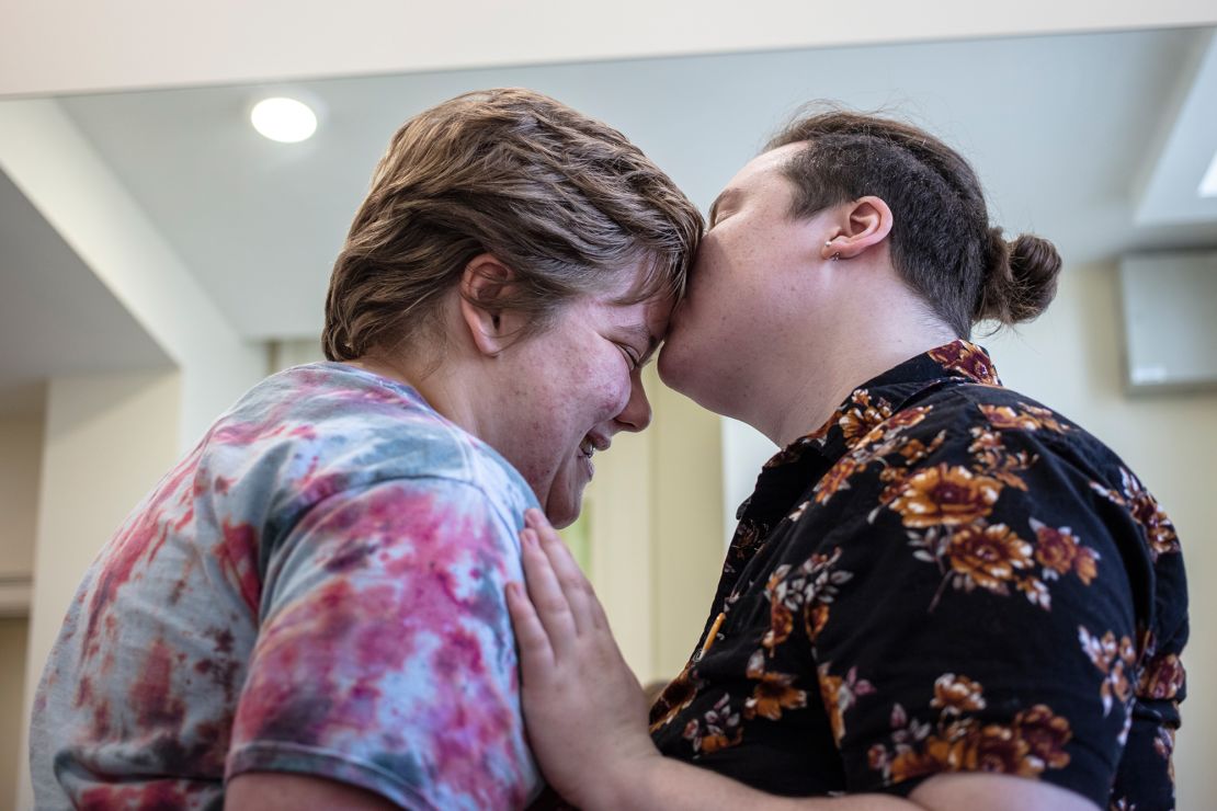 Volunteers Ezra Brown and his fiance Alex Emery embrace before the prom starts.