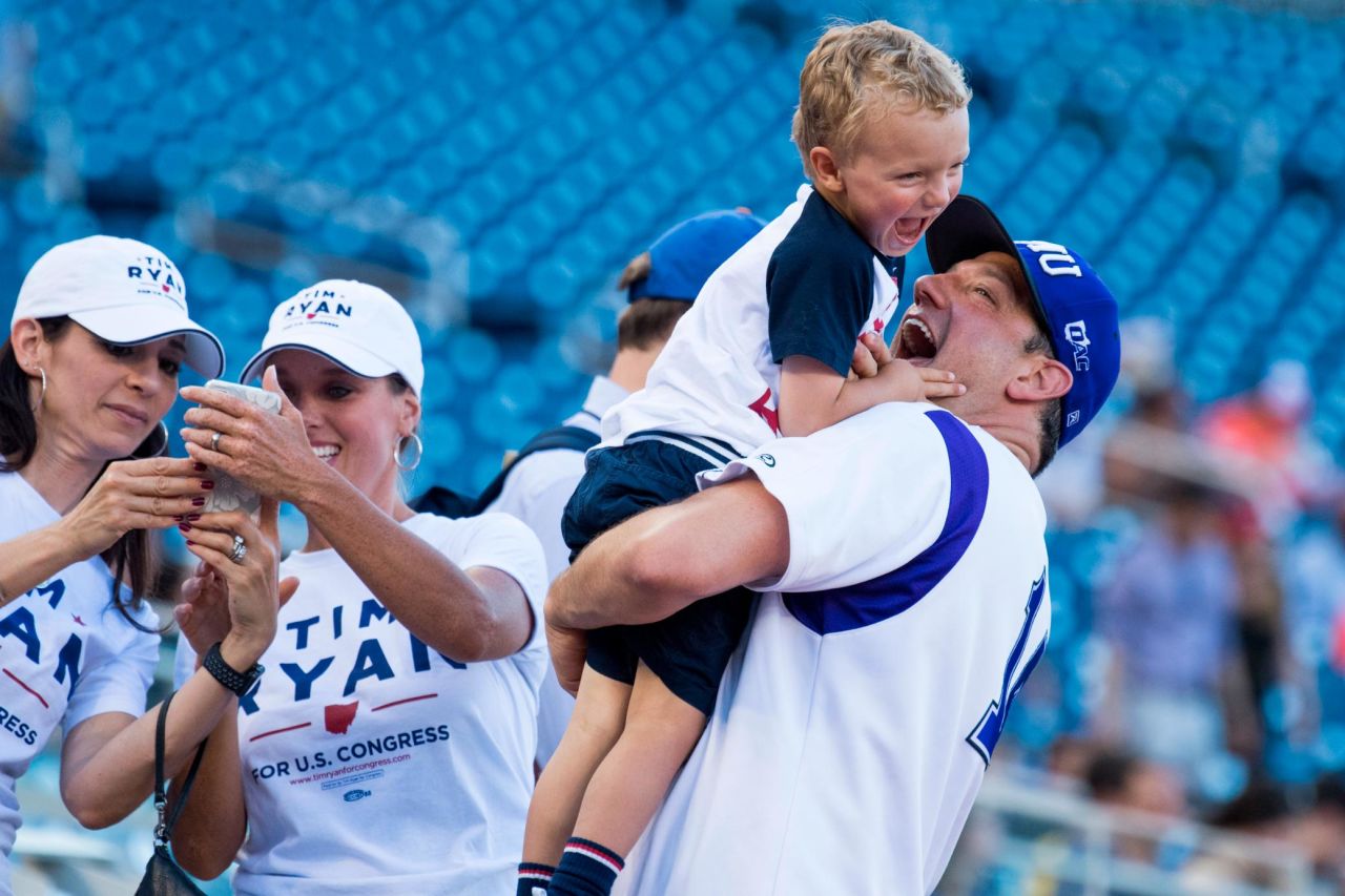 Ryan holds his son Brady before the Congressional Baseball Game in June 2018.