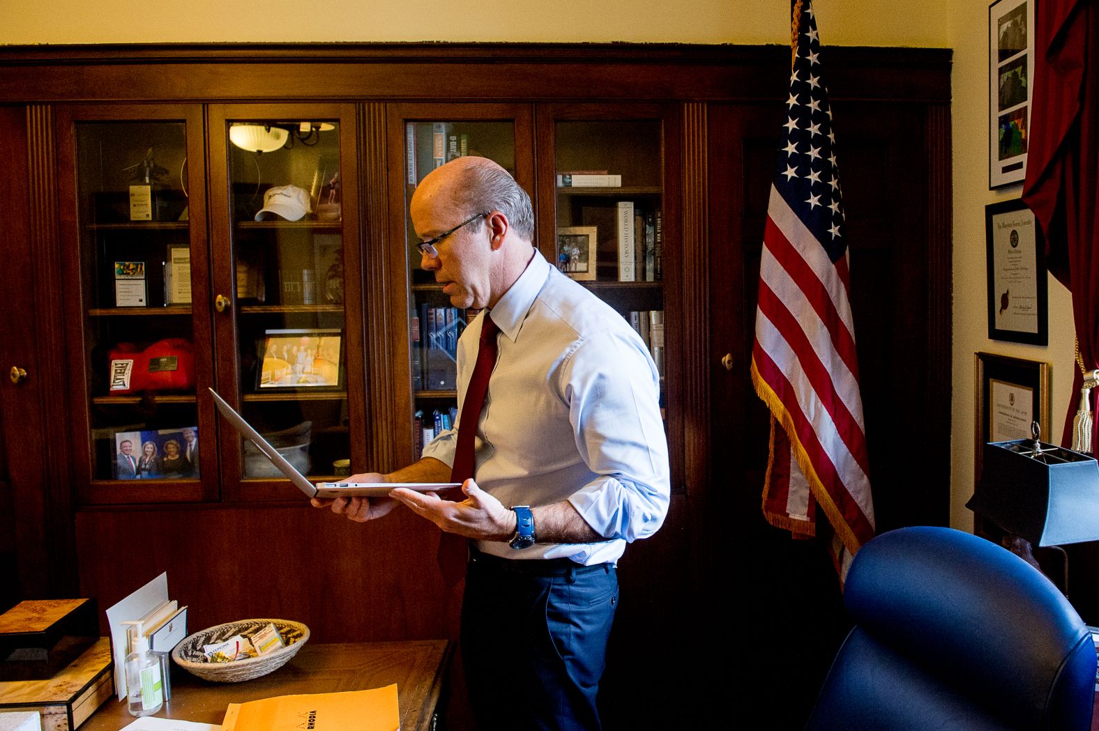 Delaney grabs his laptop while meeting with staff members in January 2015.