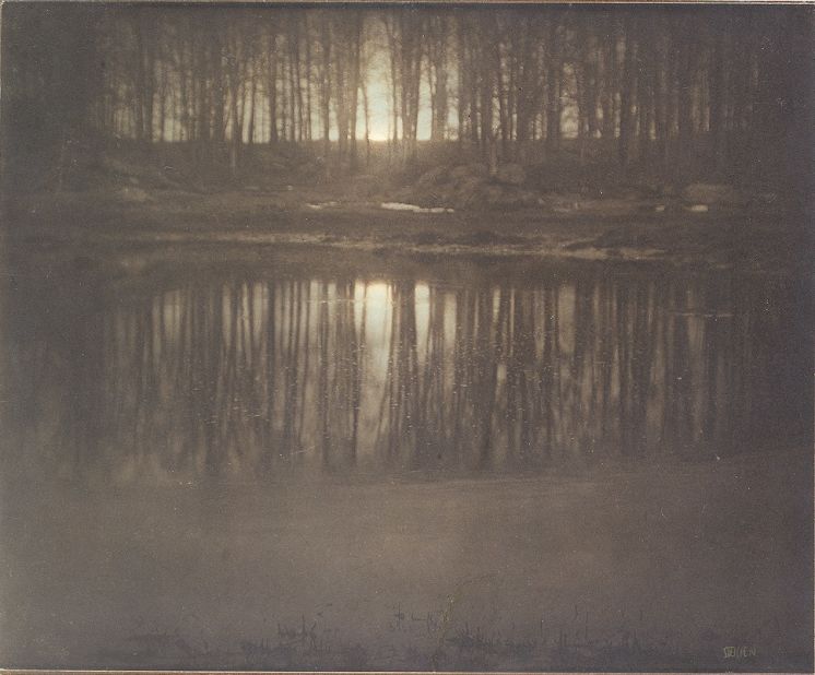Photographer Edward Steichen created this image of the moon's reflection in a pond's surface by using a complex technique of multiple printing. The artist manually applied light-sensitive gums to produce a layered effect.
