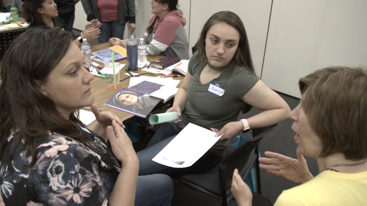 Three members of a mental health first aid class in Defiance, Ohio discuss the results of a psychosis exercise.