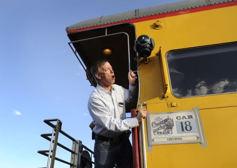 Hickenlooper gives the "all aboard" call just before a train departs Denver in July 2011.