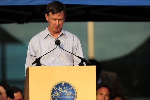 Hickenlooper bows his head while speaking at a vigil held for victims of a mall shooting in Aurora, Colorado, in July 2012.