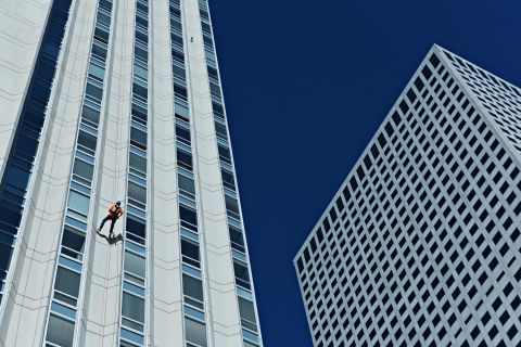 Hickenlooper rappels down a Denver skyscraper for a fundraiser in September 2016.