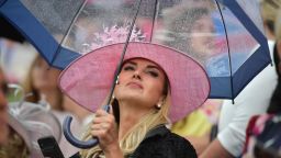 Racegoers shelter under umbrellas on day two of the Royal Ascot horse racing meet, in Ascot, west of London, on June 19, 2019. - The five-day meeting is one of the highlights of the horse racing calendar. Horse racing has been held at the famous Berkshire course since 1711 and tradition is a hallmark of the meeting. Top hats and tails remain compulsory in parts of the course while a daily procession of horse-drawn carriages brings the Queen to the course. (Photo by Daniel LEAL-OLIVAS / AFP)        (Photo credit should read DANIEL LEAL-OLIVAS/AFP/Getty Images)